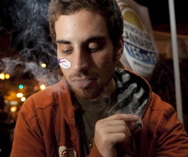 Michael Finkelstein smokes a marijuana cigarette while watching election results in Oakland, California, in 2010. Photo by David Paul Morris/Bloomberg