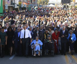 Obama participates in a march across the Edmund Pettus Bridge in Selma, Alabama