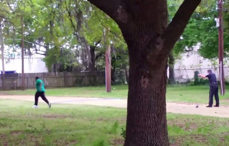 North Charleston police officer Michael Slager, right, is seen allegedly shooting 50-year-old Walter Scott in the back as he runs away, in this still image from video in North Charleston, South Carolina taken April 4, 2015. Slager was charged with murder on Tuesday. The FBI and U.S. Justice Department have begun a separate investigation. Handout photo via Reuters