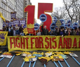 Demonstrators hold signs during demonstrations asking for higher wages in the Manhattan borough of New York