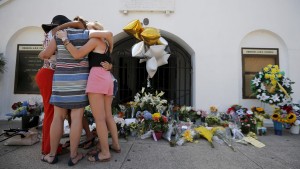Mourners hug after praying outside the Emanuel African Methodist Episcopal Church in Charleston, South Carolina June 18, 2015, a day after a mass shooting left nine dead during a bible study at the church.  REUTERS/Brian Snyder - RTX1H60G