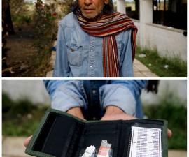 Pakistani migrant Mohamed Ayub, 51, holding the most valuable item he currently owns, his empty wallet, at a deserted hotel used by immigrants for temporary shelter on the Greek island of Kos, May 27, 2015. Photo by Yannis Behrakis/Reuters