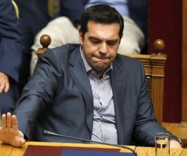 Greek Prime Minister Alexis Tsipras reacts during a voting session at the Parliament in Athens, Greece, July 11, 2015.The Greek parliament voted overwhelmingly on Saturday in favour of authorizing the left-wing government of Tsipras to negotiate with international creditors on the basis of a reform programme unveiled this week. REUTERS/Christian Hartmann - RTX1JY8P