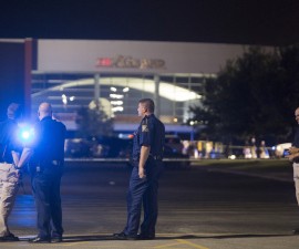Officials stand by the scene outside the movie theatre where a man opened fire on film goers in Lafayette, Louisiana July 23, 2015. A gunman opened fire at a movie theater in Lafayette, Louisiana, on Thursday evening, killing at least two persons and injuring nine others before taking his own life, according to a local ambulance company. The shooting took place during a 7 p.m. CDT (0000 GMT) showing of the film "Train Wreck" in a shooting that took place almost three years to the day after a movie theater rampage in Aurora, Colorado, police and media reported. REUTERS/Lee Celano - RTX1LLF9
