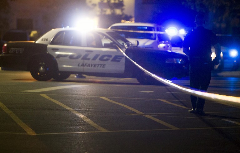 Police stand by at the scene outside the movie theatre where a man opened fire on film goers in Lafayette, Louisiana on July 23, 2015. The 58-year-old gunman opened fire inside a crowded movie theatre Thursday evening, killing two people and injuring nine others before taking his own life, police said. Photo by Lee Celano/Reuters
