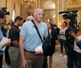 U.S Airman First Class Spencer Stone arrives surrounded by journalists to attend a ceremony at the U.S. Embassy as U.S. ambassador to France Jane Hartley presents him, student Anthony Sadler and National Guardsman Alek Skarlatos in Paris, France, August 23, 2015.  The three men helped overpower a Kalashnikov-toting attacker on a high speed train heading for Paris from Amsterdam on Friday.   REUTERS/Regis Duvignau - RTX1PBYP