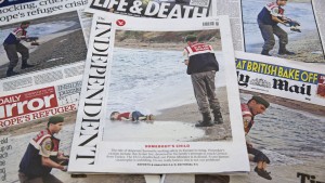 The front pages of some of Britain's daily newspapers showing an image of the body of Syrian three-year-old boy Aylan are pictured in London, on September 3, 2015. The image spread like lightning through social media and dominated front pages from Spain to Sweden, with commentators unanimous it had rammed home the horrors faced by those fleeing war and conflict in the Middle East and Africa. AFP PHOTO/JUSTIN TALLIS (Photo credit should read JUSTIN TALLIS/AFP/Getty Images)