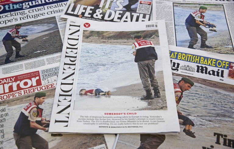 The front pages of some of Britain's daily newspapers showing an image of the body of Syrian three-year-old boy Aylan are pictured in London, on September 3, 2015. The image spread like lightning through social media and dominated front pages from Spain to Sweden, with commentators unanimous it had rammed home the horrors faced by those fleeing war and conflict in the Middle East and Africa. AFP PHOTO/JUSTIN TALLIS (Photo credit should read JUSTIN TALLIS/AFP/Getty Images)