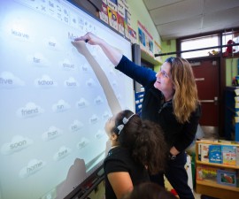 Pleasant View Elementary School  Principal Gara Field works with first grader  Rachael Rodriguez  on a word game on an interactive screen during free time in Rodriguez' class this past May. Photo by Gretchen Ertl/Hechinger Report