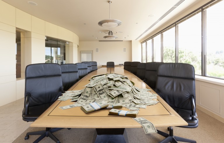 Pile of dollars on conference table