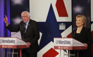 Democratic U.S. presidential candidates former Secretary of State Hillary Clinton and Senator Bernie Sanders discuss a point during the second official 2016 U.S. Democratic presidential candidates debate in Des Moines, Iowa, November 14, 2015.         REUTERS/Jim Young  - RTS73Q2