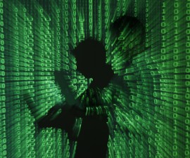 An illustration picture shows a projection of binary code on a man holding a laptop computer, in an office in Warsaw June 24, 2013. REUTERS/Kacper Pempel (POLAND - Tags: BUSINESS TELECOMS TPX IMAGES OF THE DAY) - RTX10ZB5