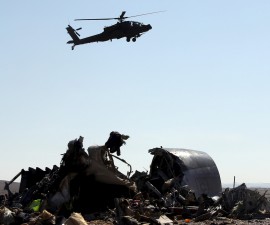 An Egyptian military helicopter flies over debris from a Russian airliner which crashed at the Hassana area in Arish city, north Egypt, November 1, 2015. Russia has grounded Airbus A321 jets flown by the Kogalymavia airline, Interfax news agency reported on Sunday, after one of its fleet crashed in Egypt's Sinai Peninsula, killing all 224 people on board. REUTERS/Mohamed Abd El Ghany - RTX1U8ZT
