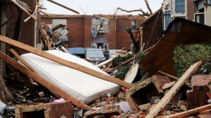 Damaged cars sit amidst the debris at the tornado-damaged Landmark at the Lake Village West apartment complex in Garland, Texas, December 28, 2015. In Texas, at least 11 people were killed in the Dallas area over the weekend by tornadoes, including one packing winds of up to 200 miles per hour (322 km per hour). The twister hit the city of Garland, killing eight people and blowing vehicles off highways.  REUTERS/Todd Yates - RTX20BX8