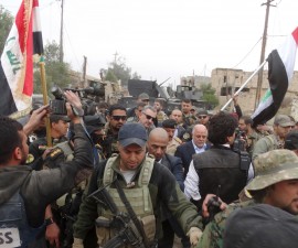 Iraqi Prime Minister Haider al-Abadi walks with his security detail in the city of Ramadi, December 29, 2015. Abadi on Tuesday visited Ramadi a day after the army retook the city centre from Islamic State, a victory that could help vindicate his strategy for rebuilding the military after stunning defeats in the past 18 months. REUTERS/Stringer EDITORIAL USE ONLY. NO RESALES. NO ARCHIVE TPX IMAGES OF THE DAY - RTX20F5P