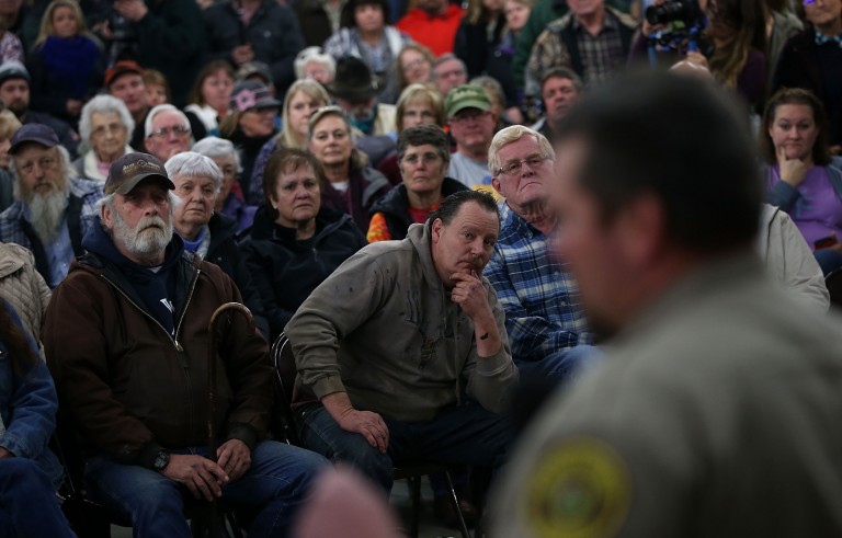 Harney County residents in rural Oregon look on as Harney County Sheriff David Ward speaks during a community meeting at the Harney County fairgrounds in Burns, Oregon. Jan. 6, 2016. Hundreds of Harney County residents attended a community meeting to express frustration and support over an armed anti-government militia group that continues to occupy the Malheur National Wildlife Headquarters. Photo by Justin Sullivan/Getty Images