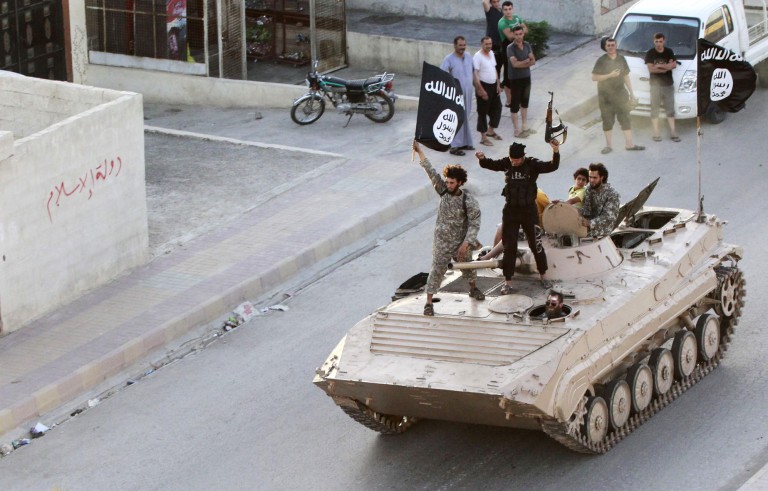 Militant Islamist fighters take part in a military parade along the streets of northern Raqqa province on June 30, 2014. Photo by Stringer/Reuters