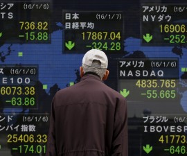 A pedestrian looks at an electronic board showing the stock market indices of various countries outside a brokerage in Tokyo, Japan, January 7, 2016. Japanese stocks fell on Thursday morning after China's central bank weakened the yuan - sparking a sharp strengthening of the yen, hurting exporters and tarnishing sentiment in a market already on edge over geopolitical tensions and signs that China's economy is slowing. REUTERS/Yuya Shino TPX IMAGES OF THE DAY      - RTX21CKS
