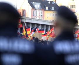 Police watch as supporters of anti-immigration right-wing movement PEGIDA (Patriotic Europeans Against the Islamisation of the West) take part in a demonstration march, in reaction to mass assaults on women on New Year's Eve, in Cologne, Germany, January 9, 2016.     REUTERS/Ina Fassbender TPX IMAGES OF THE DAY   - RTX21N28