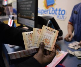 A customer shows their tickets for the Powerball lottery at the CA lotto store in San Bernardino County, California on the California-Nevada state line January 9, 2016.  Millions of Americans anxiously awaited Saturday night's drawing in the multi-state Powerball lottery hoping to win a jackpot that has climbed to a record $900 million and could top $1 billion before the frenzy to buy tickets ends, officials said.  California, the nation's most populous state, normally sees Powerball sales of $1 million a day, but on Saturday morning sales were a head-spinning $2.8 million an hour, said California Lottery spokesman Mike Bond.   REUTERS/Gene Blevins - RTX21OW9