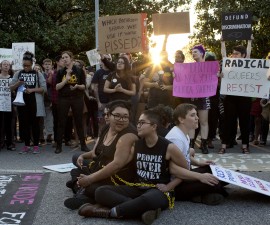 Front from left, demonstrators Jess Jude, Loan Tran and Noah Rubin-Blose, sit chained together in the middle of the street during a protest against House Bill 2 on Thursday, March 24, 2016, outside of the Governor's Mansion on North Blount Street in downtown Raleigh, N.C. (Jill Knight/Raleigh News & Observer/TNS via Getty Images)