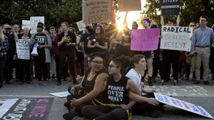 Front from left, demonstrators Jess Jude, Loan Tran and Noah Rubin-Blose, sit chained together in the middle of the street during a protest against House Bill 2 on Thursday, March 24, 2016, outside of the Governor's Mansion on North Blount Street in downtown Raleigh, N.C. (Jill Knight/Raleigh News & Observer/TNS via Getty Images)
