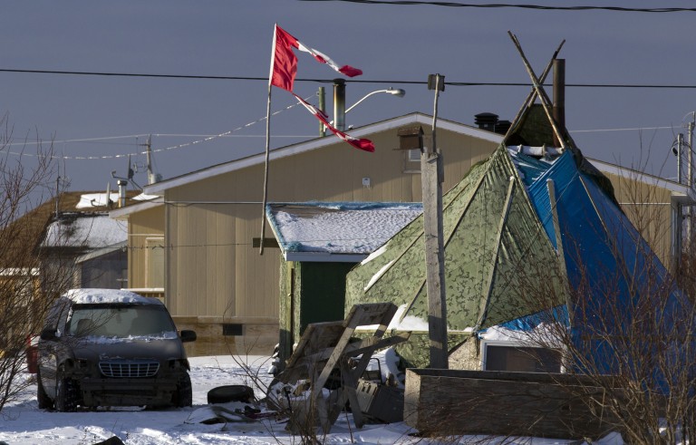 A tattered Canadian flag flies over a teepee in Attawapiskat, Ontario, December 17, 2011. About 20 families will move into a temporary shelter on December 23 to escape the housing crisis at the aboriginal reserve of Attawapiskat where many households live without running water or sanitary facilities, according to local media. Photo by Frank Gunn/Pool/via Reuters