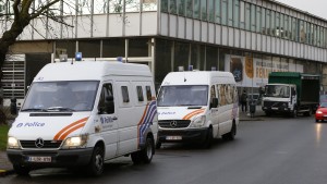 A Police officer stands in front of a car dearlership during a police operation after fugitive Mohamed Abrini was arrested in Anderlecht, near Brussels, Belgium, April 8, 2016. REUTERS/Yves Herman - RTSE7OI