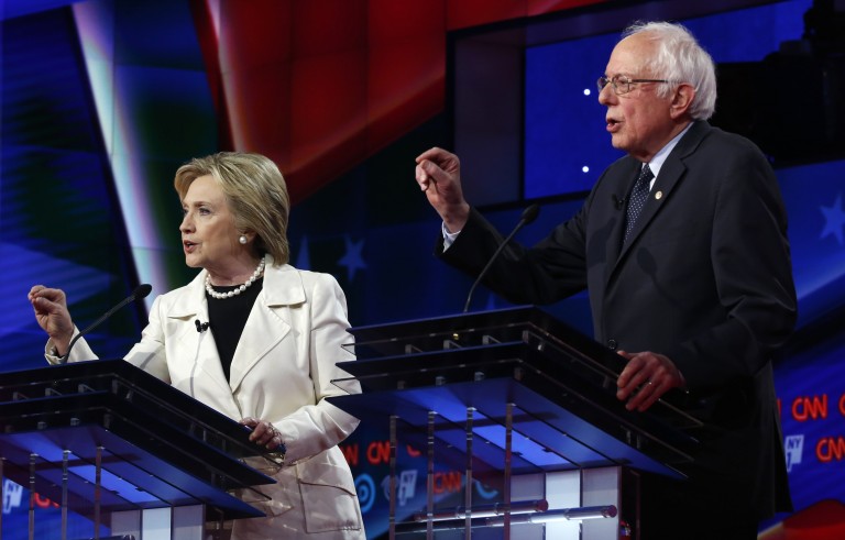 Democratic U.S. presidential candidates Hillary Clinton (L) and Senator Bernie Sanders speak simultaneously during a Democratic debate hosted by CNN and New York One at the Brooklyn Navy Yard in New York April 14, 2016. Photo by Lucas Jackson/Reuters
