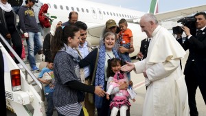 Pope Francis welcomes a group of Syrian refugees after landing at Ciampino airport in Rome following a visit at the Moria refugee camp in the Greek island of Lesbos, April 16, 2016. REUTERS/ Filippo Monteforte/Pool      TPX IMAGES OF THE DAY - RTX2A8LK