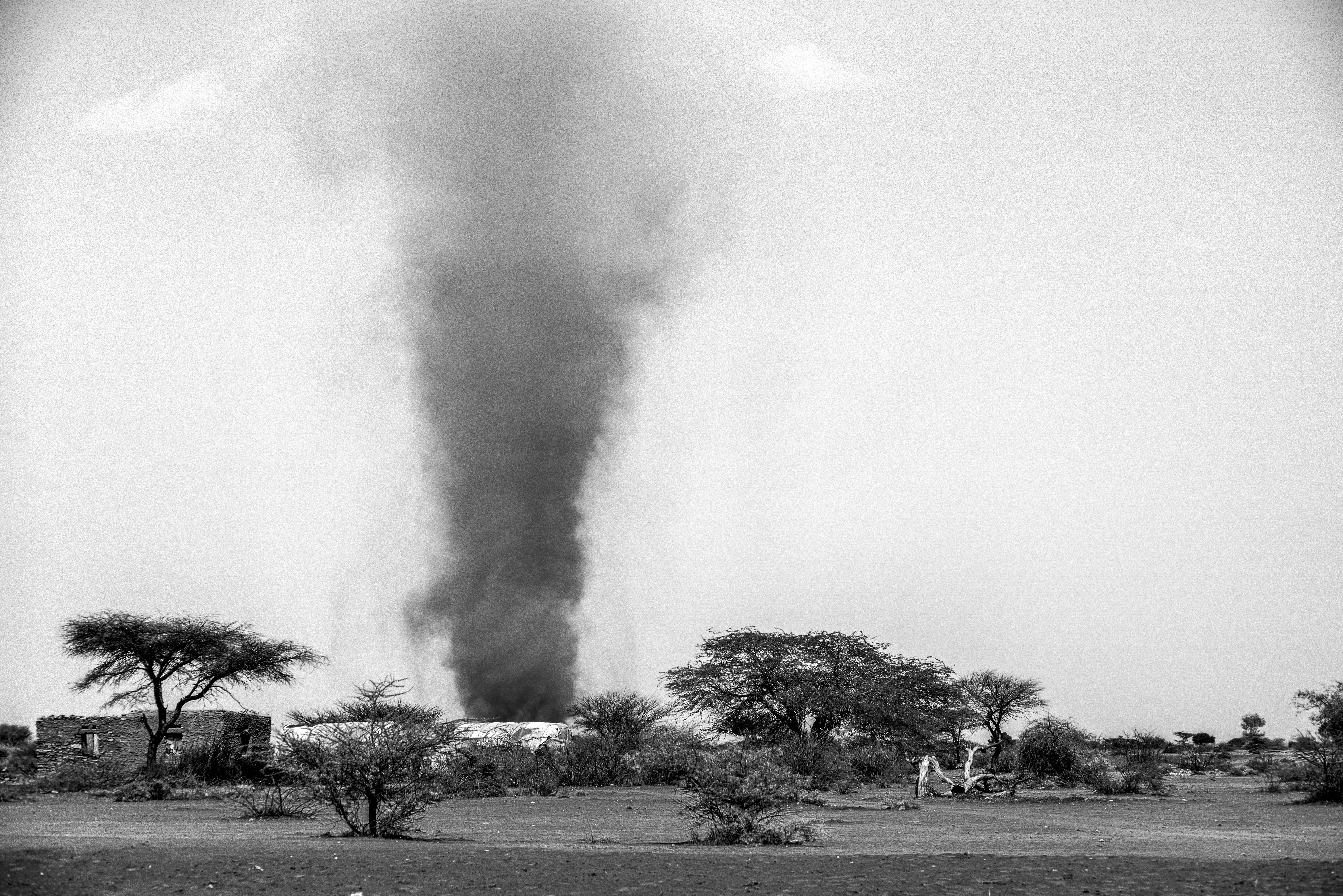 The searing heat creates a huge dust devil that cuts through a small village in the region of Somaliland in northern Somalia. Photo by Sebastian Rich for UNICEF