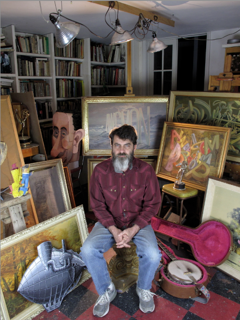 artist wayne white with paintings in studio