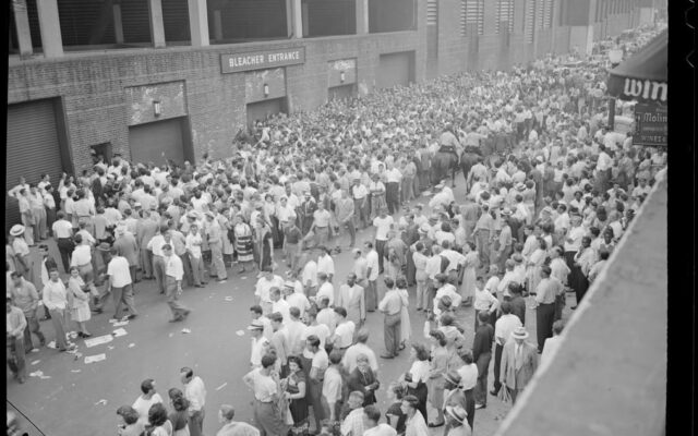 Crowd milling about bleachers entrance at Fenway Park