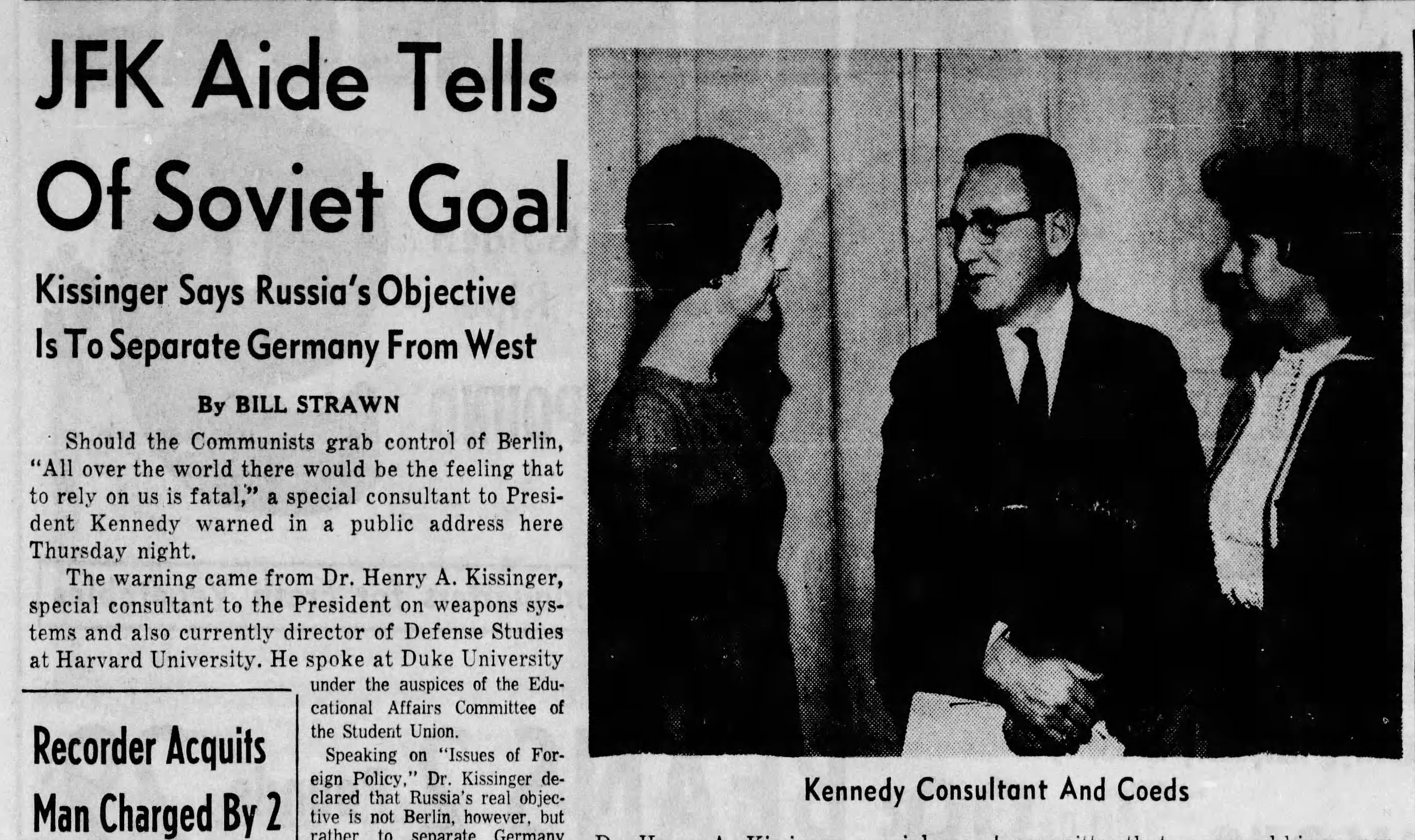 The Herald Sun October 27, 1961. Newspaper clipping with the headline JFK Aide Tells of Soviet Goal. To the right is a black and white photo of Henry Kissinger speaking with two women.