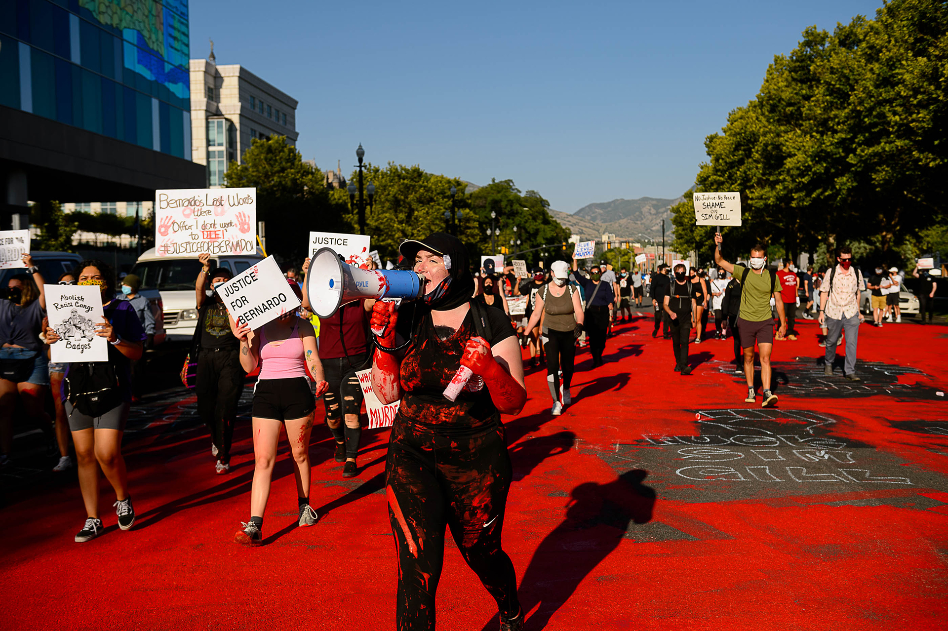 Protesters march after painting the street red in front of the Salt Lake County District Attorney’s Office in Salt Lake City on Thursday, July 9, 2020.