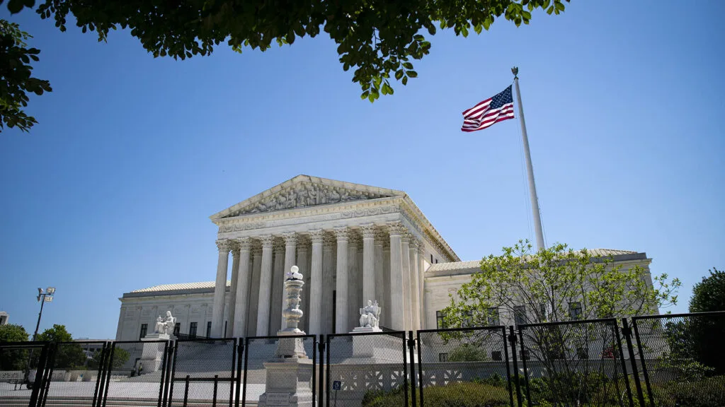 Security fencing surrounds the U.S. Supreme Court in Washington, D.C., on June 29, 2022. FRONTLINE documentaries offer context on the court's just-ended term, as well as recent decisions on abortion, guns, the environment and more.