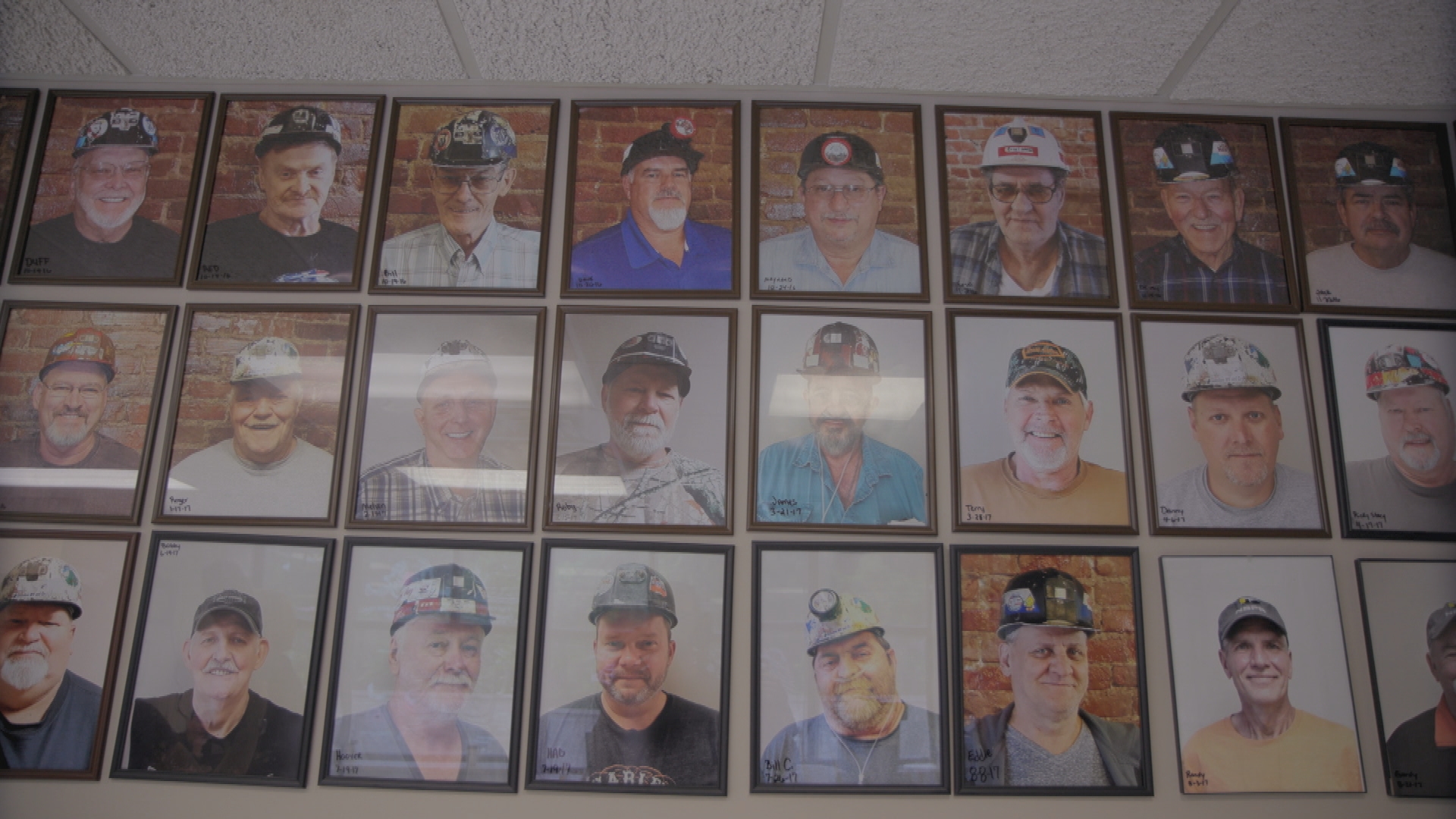 A wall of photos of miners.