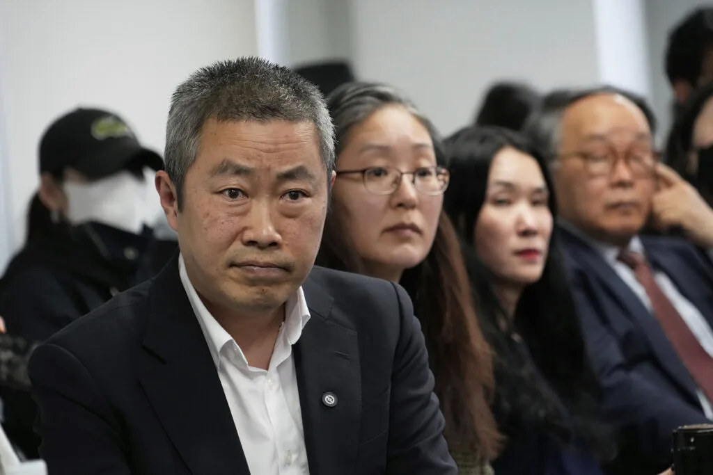 Peter Møller, left, Boonyoung Han, second from left, and Yooree Kim at a press conference.