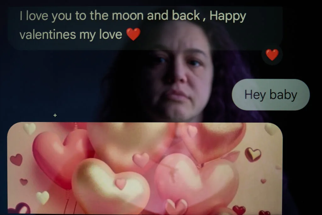 A woman is reflected on a screen that has a message reading "I love you to the moon and back, Happy valentines my love." It also has an image with hearts.