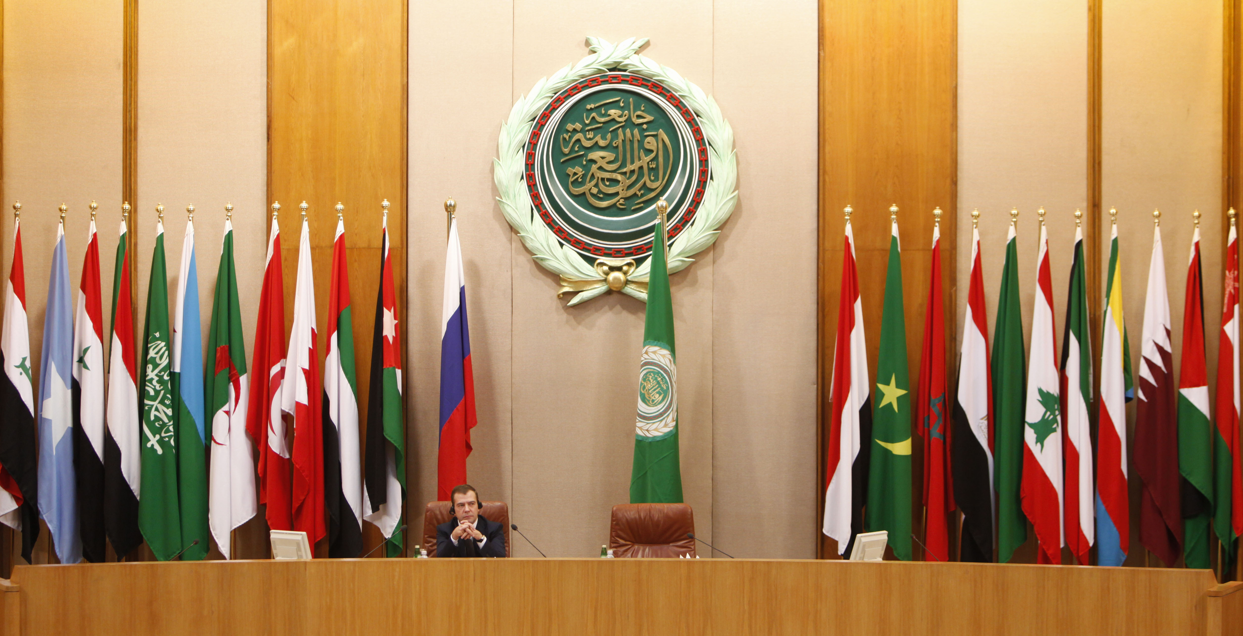 Backdropped with Arab countries flags and the logo of the Arab League, Russian President Dmitry Medvedev attends a meeting with Arab League representatives, unseen before delivers a speech, during a visit to Arab League headquarters in Cairo, Egypt, Tuesday, June 23, 2009. Medvedev, on a visit to Egypt, said Tuesday he sees some progress towards resolving the Israel-Palestinian dispute and is continuing to push for an international conference on the issue in Moscow. (AP Photo/Nasser Nasser)