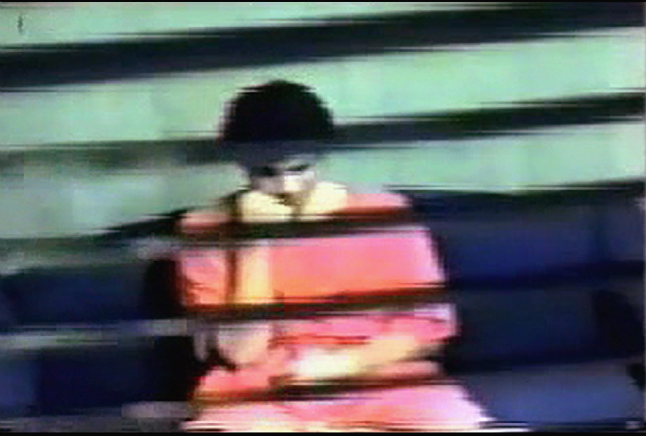 In this file handout image taken from a 2003 U.S. Department of Defense surveillance video and provided Tuesday, July 15, 2008 by Omar Khadr's defense lawyers, Khadr is shown in an interrogation room at the Guatanamo U.S. Naval Base prison while being questioned by members of the Canadian Security Intelligence Service. A decade after Khadr was pulled near death from the rubble of a bombed-out compound in Afghanistan, the Canadian citizen set foot on Canadian soil early Saturday, Sept. 29, 2012, after an American military flight from the notorious prison in Guantanamo Bay. Khadr pleaded guilty in 2010 to killing a U.S. soldier in Afghanistan and was eligible to return to Canada from Guantanamo Bay last October under terms of a plea deal. Canada's conservative government took almost a year to approve the transfer. (AP Photo/U.S. Department of Defense via The Canadian Press, File)