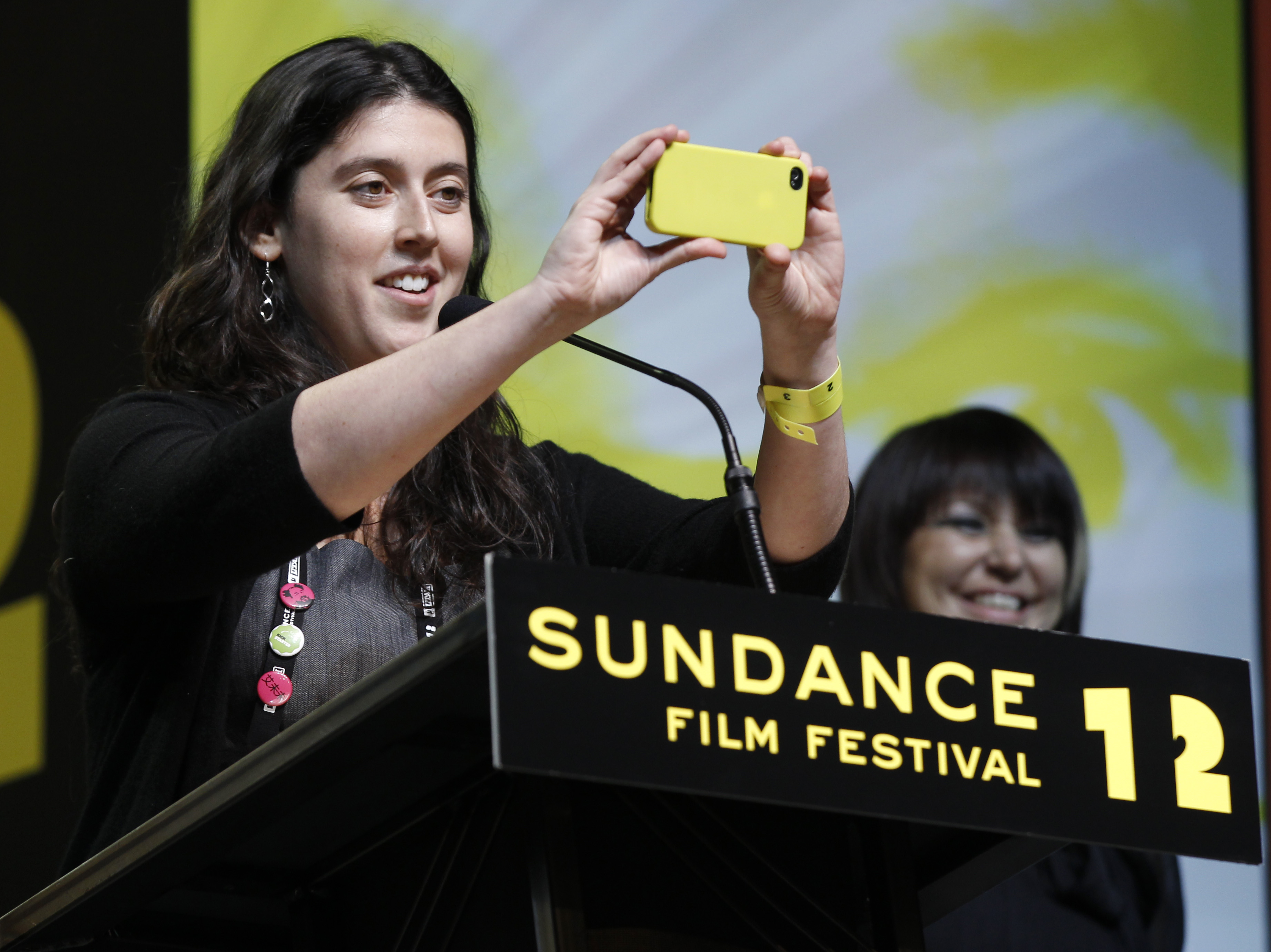 Director Alison Klayman takes a photo after asking the audience to give her the middle finger as she accepts the U.S. Documentary Special Jury Prize: Documentary for the film "Ai Weiwei: Never Sorry" during the 2012 Sundance Film Festival Awards Ceremony in Park City, Utah on Saturday, Jan. 28, 2012.