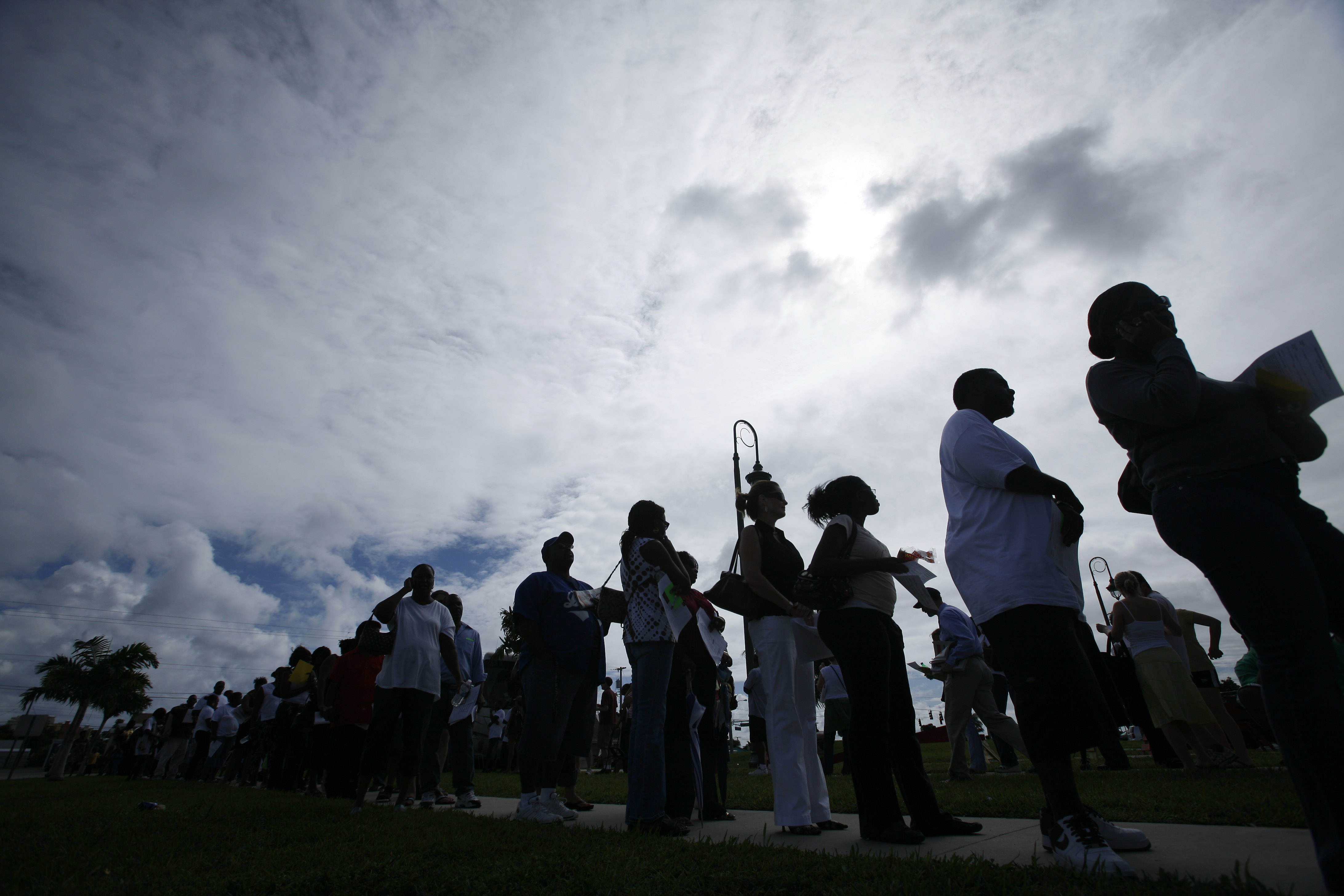 People stand in line to vote early Sunday, Nov. 2, 2008 in Riviera Beach, Fla.