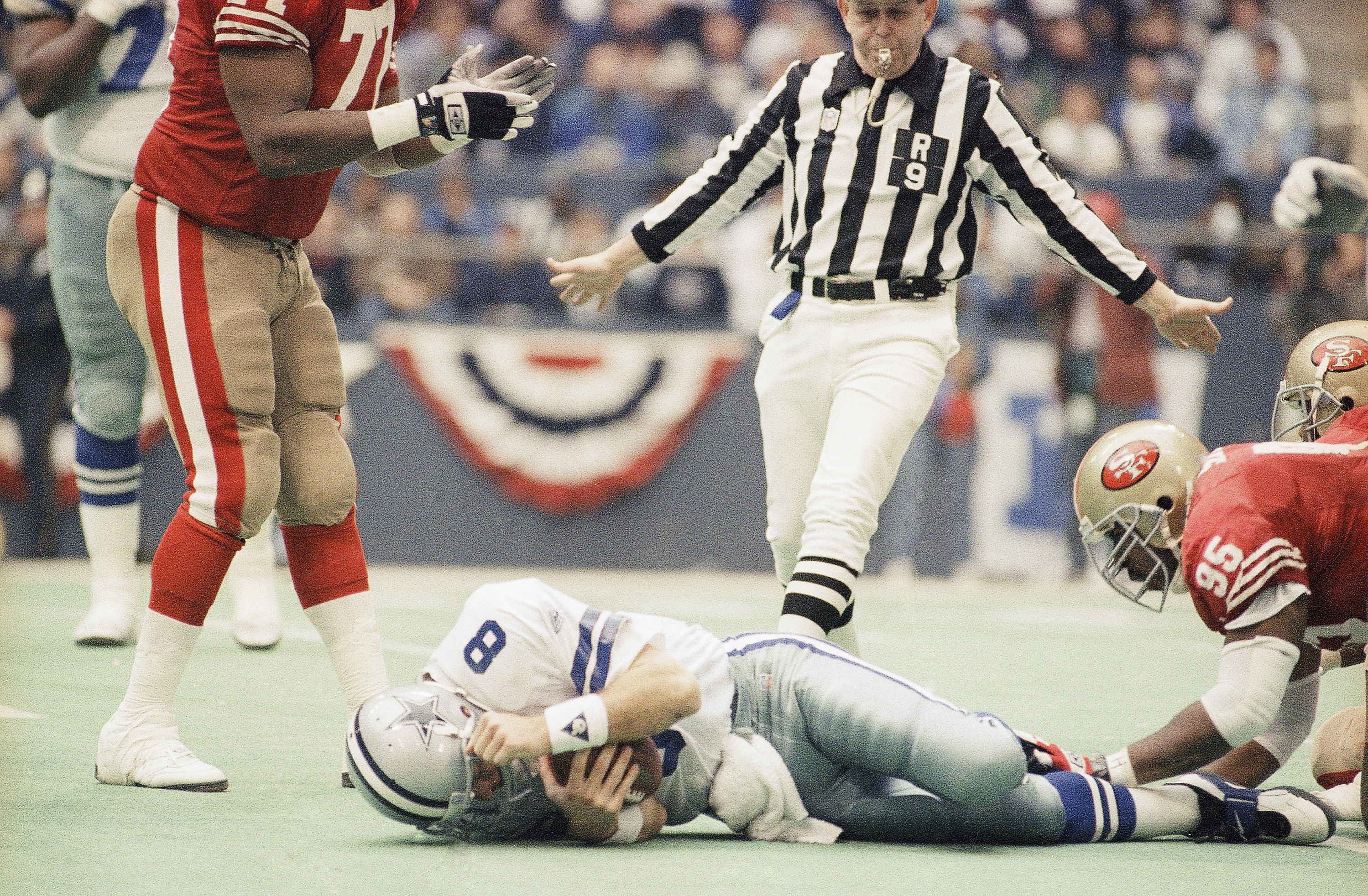 San Francisco 49ers defensive tackle Artie Smith (95) approaches Dallas Cowboys quarterback Troy Aikman (8) after Aikman was kneed in the head by 49ers and Dennis Brown in the third quarter of the NFC championship gamel, Sunday, Jan. 23, 1994 in Irving, Texas. Aikman was taken out of the game. The Cowboys won, 38-21.