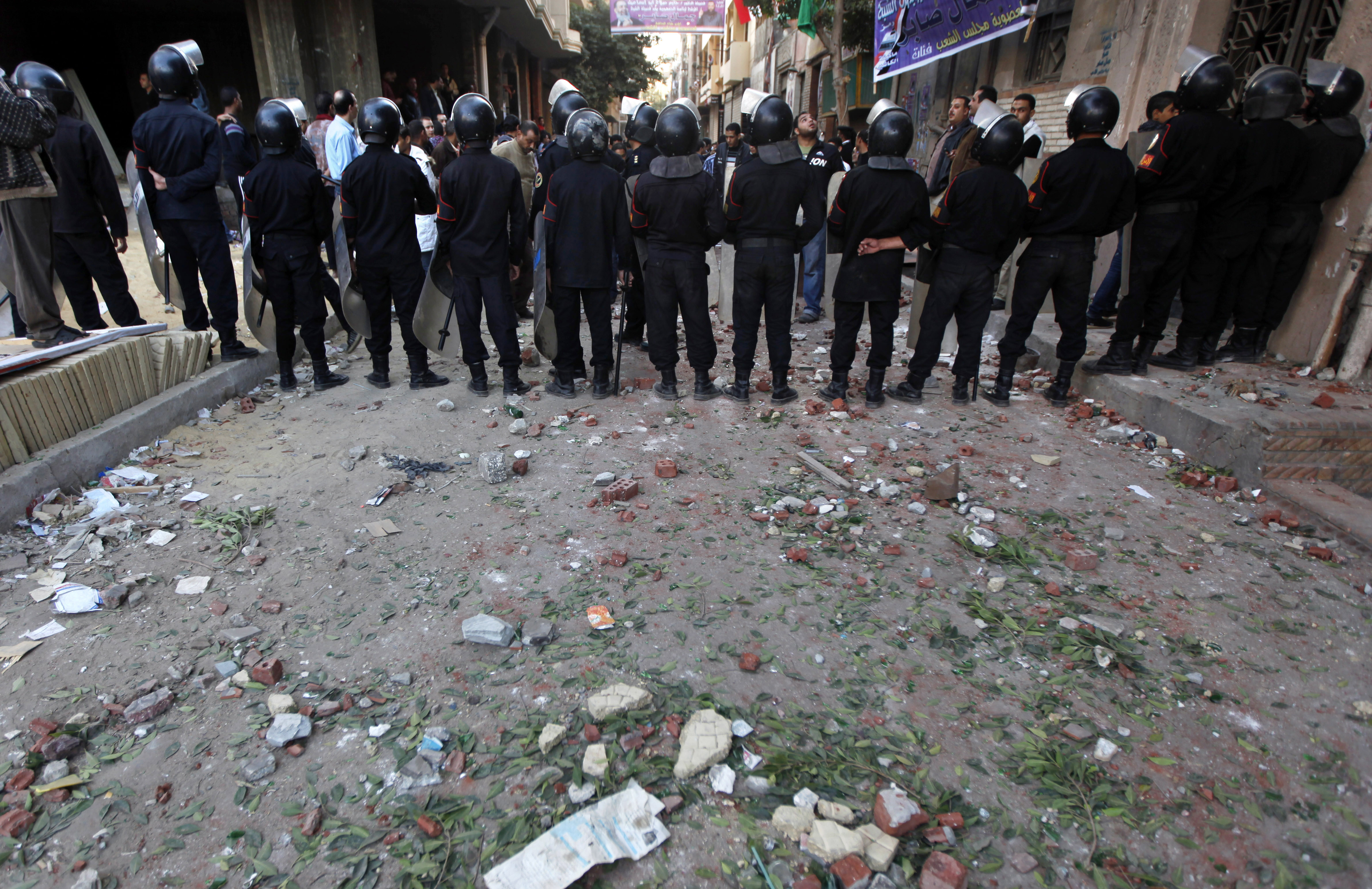 Egyptian riot police block a street after violent clashes between Muslims and Copts in the Shubra neighborhood of Cairo, Egypt, Thursday, Nov. 17, 2011. Attackers threw objects at a Coptic Christian march in Cairo, injuring 10 people, witnesses said.