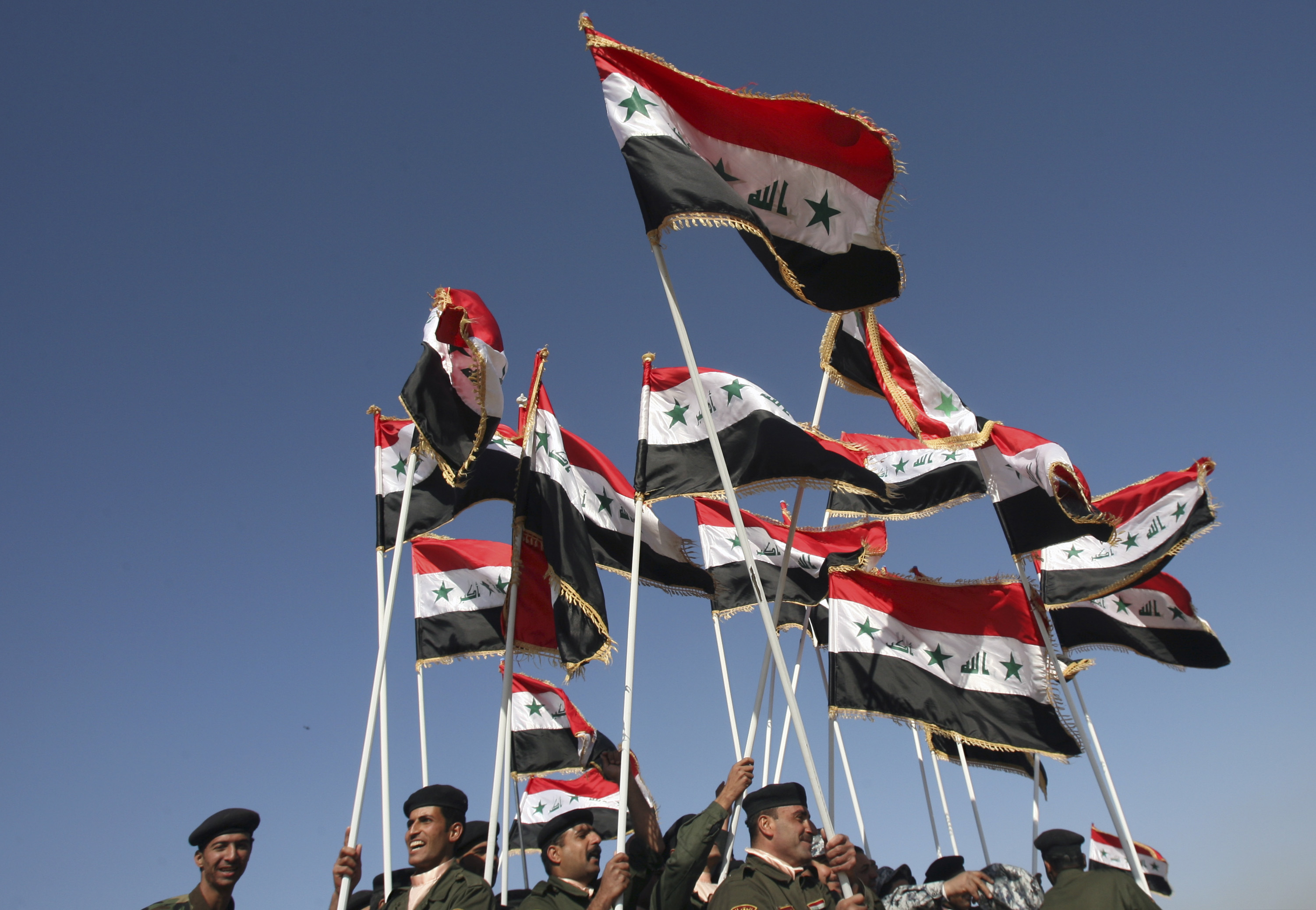 Iraqi National Police cadets carry their national flag at a graduation ceremony in southern Baghdad, Iraq on Tuesday, Jan. 8, 2008. The National Police Training School graduated 700 cadets on Tuesday.