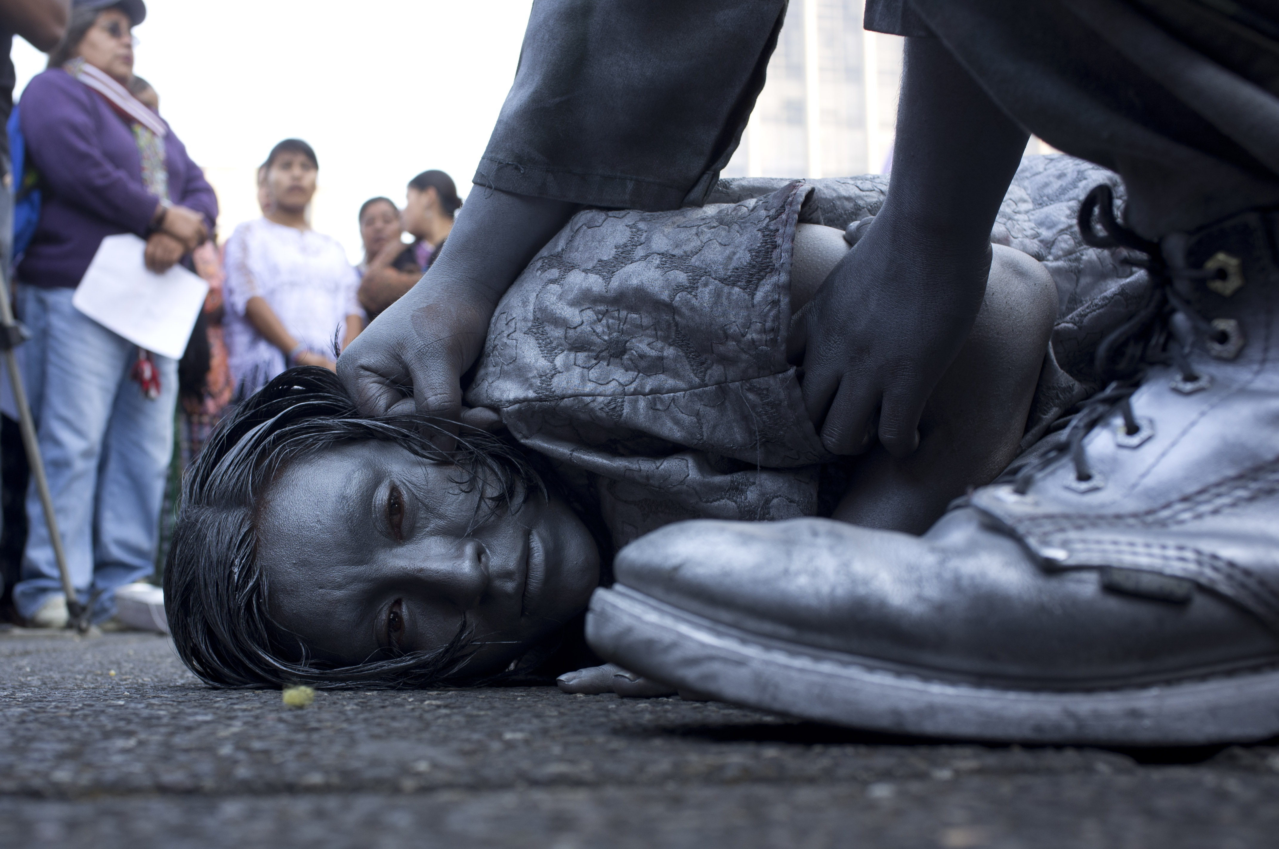 Activists represent through a performance violence against women during a rally on International Women's Day in front of the Supreme Court at Guatemala City, Friday, March 8, 2013. (AP Photo/Moises Castillo)