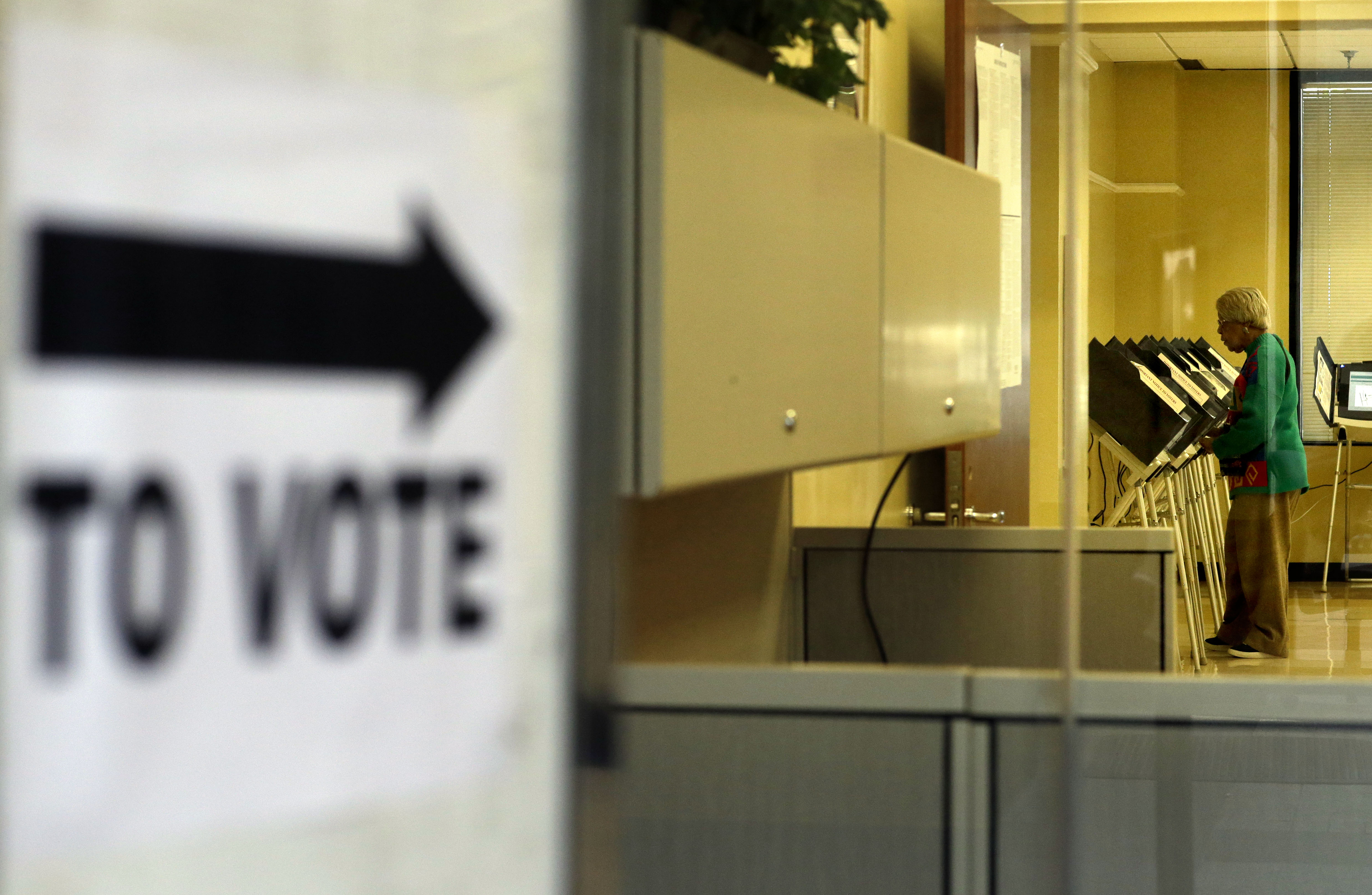 A woman casts her ballot at a polling station open for early voting in the Fulton County Government Center ahead of Georgia's upcoming May 20 primary elections, Tuesday, May 6, 2014, in Atlanta. Early voting in Georgia began April 28 and runs through May 16. (AP Photo/David Goldman)