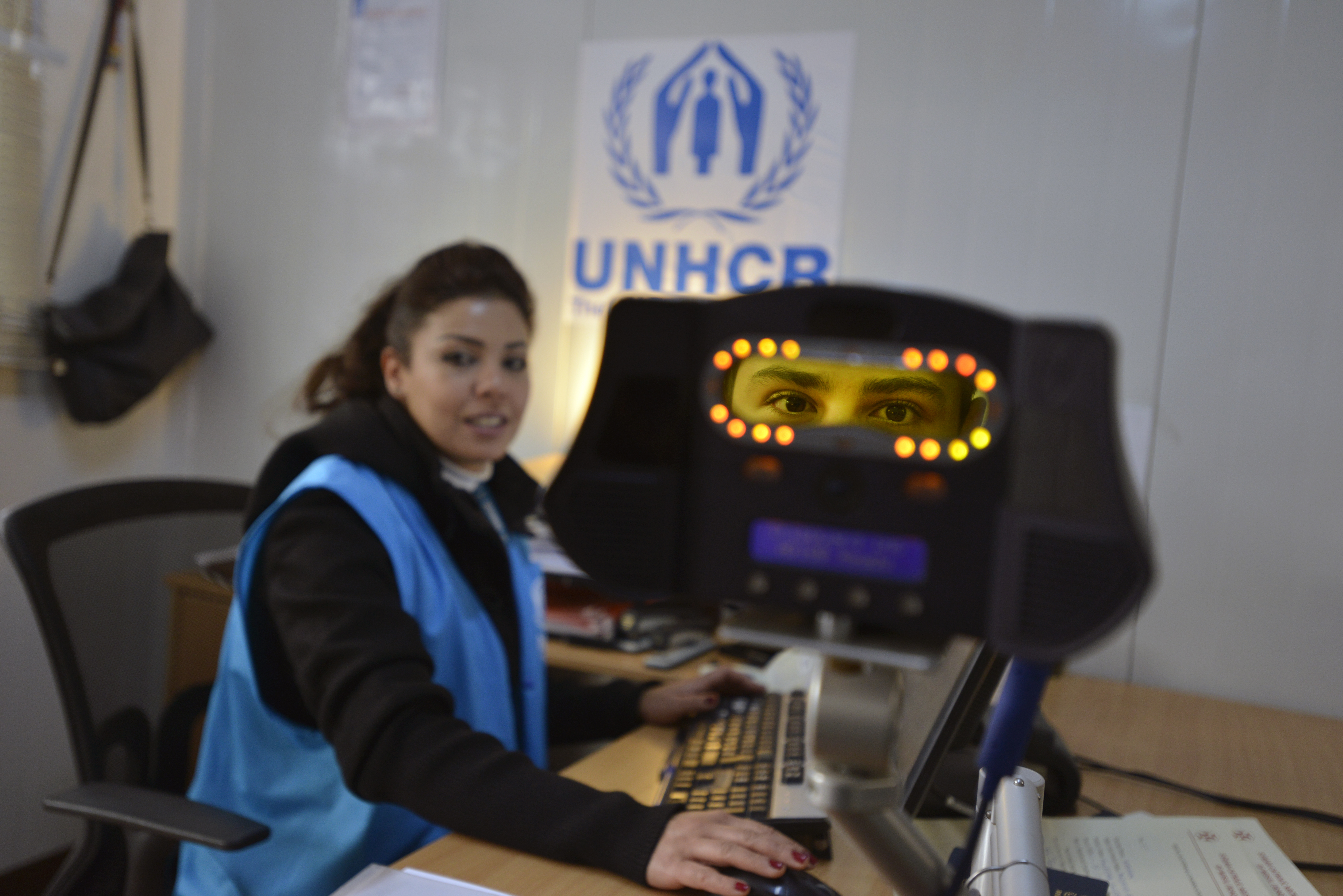 UNHCR staff process new refugees using the new iris scanning technology at the UNHCR first registration point in Amman Jordan.