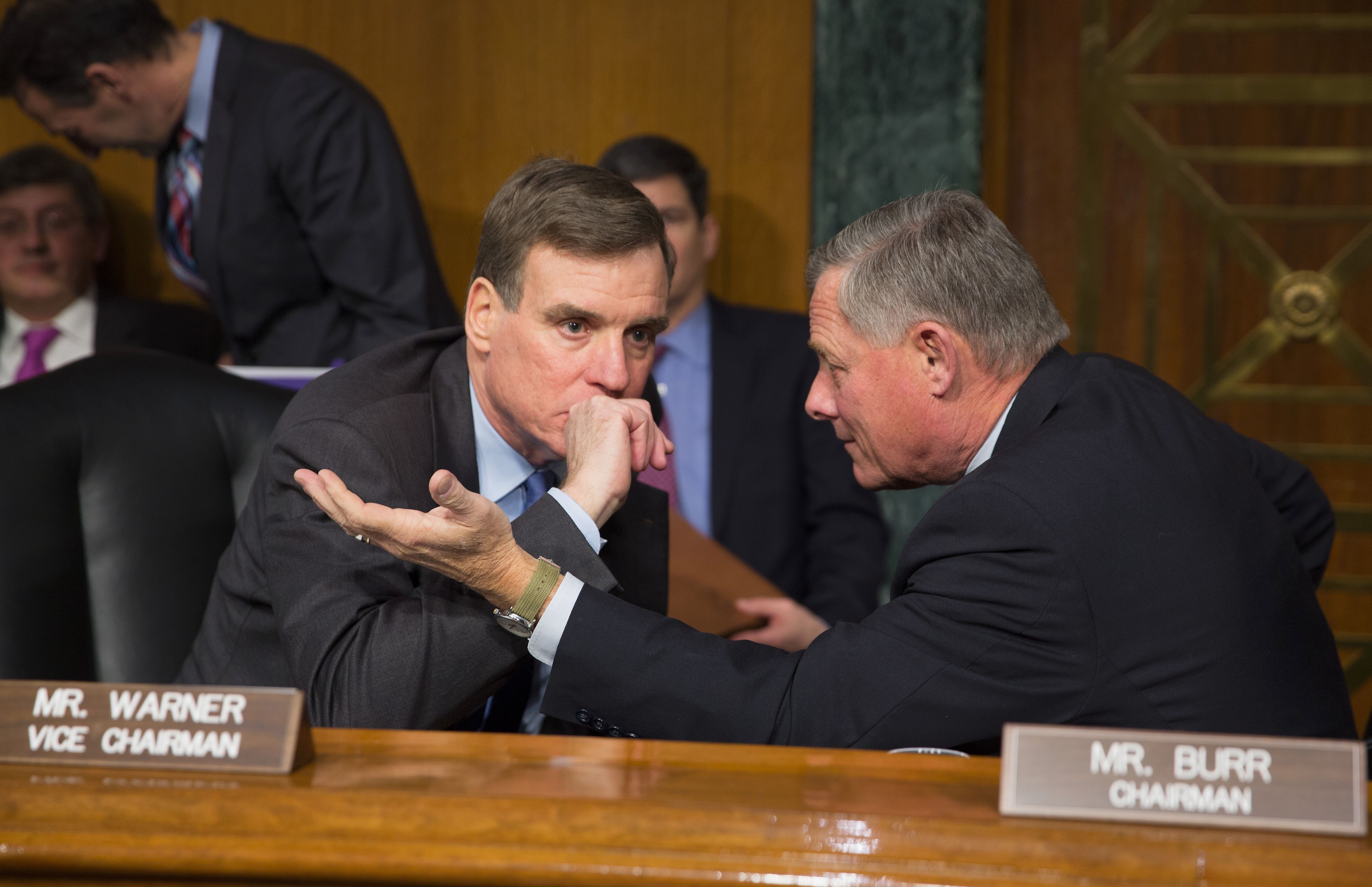 Senators Mark  Warner D-Virginia and Richard Burr R-North Carolina talk before a Senate Armed Services Committe hearing on Russian Intelligence Activities on Capitol Hill in Washington, DC January 10, 2017.  / AFP / Tasos Katopodis        (Photo credit should read TASOS KATOPODIS/AFP/Getty Images)